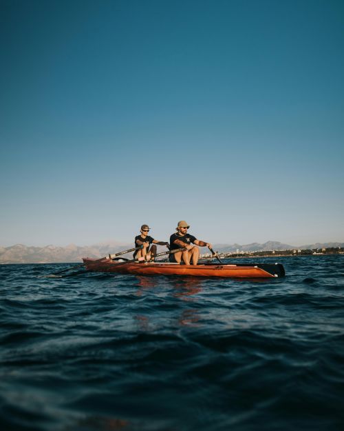Two men rowing in the open ocean